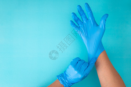 蓝色背景上戴橡胶手套的双手预防卫生医生医疗药品橡皮手指乳胶医院手术图片