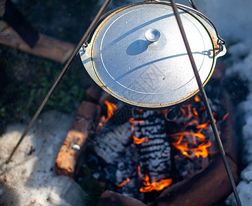 火上挂着一个煮饭的锅野餐背包摄影篝火休闲自然木头午餐生存燃烧图片