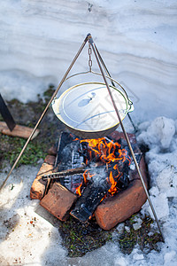 火上挂着一个煮饭的锅午餐背包生存锅炉篝火平底锅木头橙子旅行休闲图片