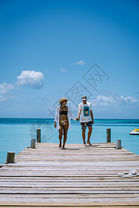 阿鲁巴加勒比棕榈海滩 在阿鲁巴有棕榈树的白长沙沙滩度假村码头奢华天蓝色蜜月假期旅行男人女士异国图片