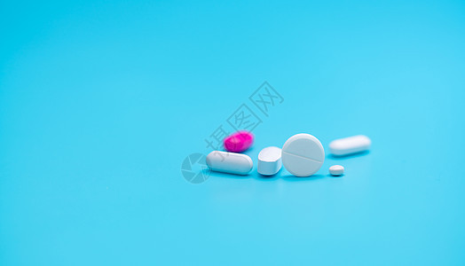 白色药丸模糊粉红色药丸和蓝色背景 药房横幅 医药行业 健康保险战略 处方药 多药和药物相互作用问题图片