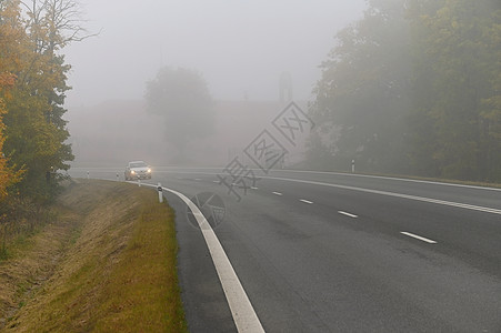 汽车在雾中的路上 秋季景观冬季危险的道路交通季节天气旅行挡风玻璃阴霾碰撞运输大灯头灯速度图片