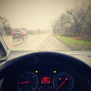 从司机看带方向盘和仪表板的汽车内部 冬天恶劣的多雨天气和危险的道路驾驶交通玻璃雨滴反射状况车辆旅行运输车轮安全图片