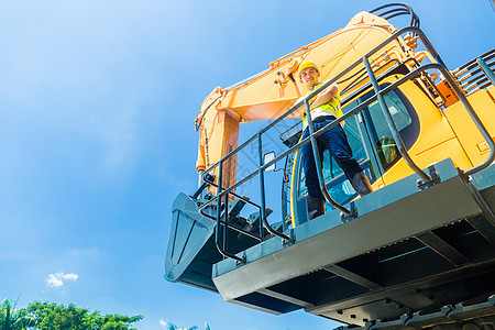 铁铲挖土机亚洲建筑工人工程领班司机安全工作头盔橙子黄色员工男人图片