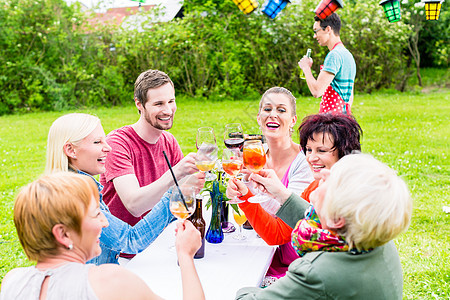 人们在派对上敬酒 在烧烤时的背景人食物夫妻团体老年人啤酒房子眼镜祖父母朋友们花园图片
