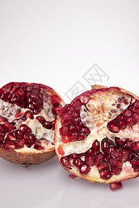 新鲜的成熟切片石榴水果 白种红种子孤立于白底宏观营养白色石榴石热带红色形象异国植物情调图片
