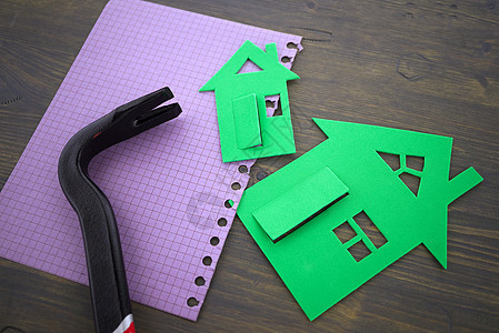 用笔记本上的手工具绿色切除模范房屋住房建筑抵押房地产建筑学记事本项目投资住宅建设图片