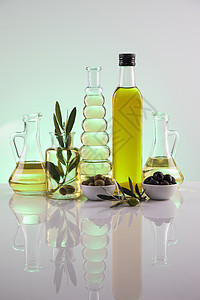 橄榄油瓶 橄榄枝和烹饪油食物蔬菜向日葵液体敷料美食桌子饮食黄色玻璃图片