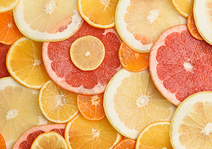 柑橘类水果切成圆形 橙子 葡萄柚 柠檬 橘子 成熟多汁的水果果汁黄色营养热带圆圈工作室红色食物柚子图片