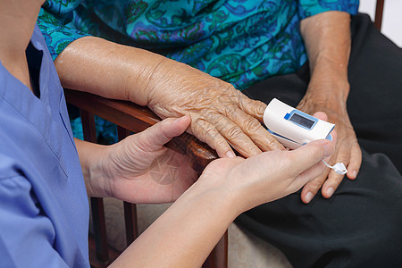 护理员监测老年妇女指尖的氧饱和度情况心脏护士医疗病人护理医院女性照顾者祖母监视器图片
