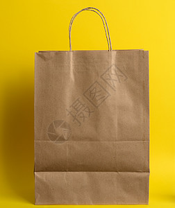 白色棕色工艺品包 有黄色背景的产品和物品的把手柄图片