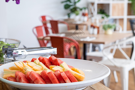 把西瓜和菠萝的碎片切成白色 餐具和花瓶放在桌边装饰餐厅自助餐上 在酒店自我服务美食小吃食物桌子热带水果团体甜点墙纸饮食图片