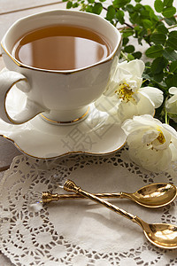 茶杯 白木桌上有小玫瑰图片