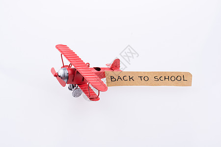 挂着旗帜的小飞机模型商业红色双翼白色学校绘画航班旅行蓝色空气图片