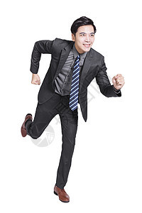 英俊的年轻商务人士望着前方跑步 孤立于白人背景套装商业快乐微笑领导竞赛办公室公司男性经理图片