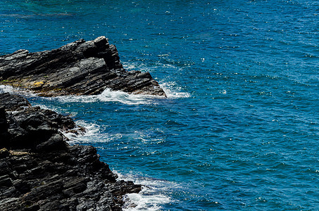 令人惊叹的海洋 有蓝色夏季波浪和岩石 对岩石和水的轻松透视海浪旅游边缘悬崖水晶风暴阳光美丽天空海岸图片