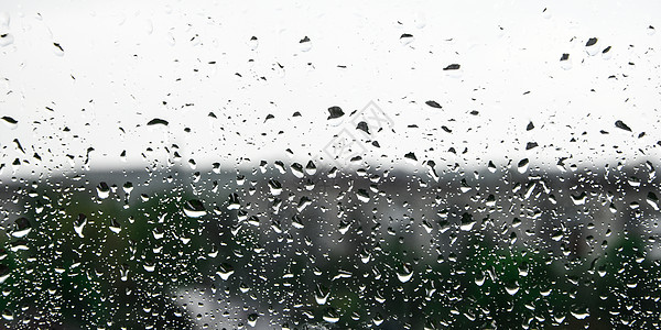 在美丽的天空背景的窗口上下着雨滴落紫色下雨日落液体雨滴阳光玻璃水滴天气太阳图片