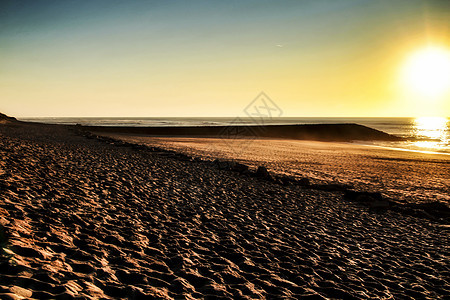 葡萄牙阿维罗海滩的日落太阳海洋村庄地平线天空蓝色海岸阳光旅行季节图片