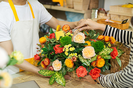 在花店里给女人送花花的花束花艺装饰店铺女性女士桌子花瓶商业植物作坊图片
