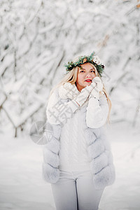 一个穿着白色衣服的女人在寒冷的冬天森林里的画像 在白雪覆盖的冬季森林里 头戴花环的女孩镜头雪花艺术裙子花园假期新年季节木头帽子图片