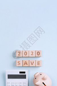 2020 年目标财务计划抽象设计概念蓝桌背景木块与存钱罐和计算器顶视图平面布局复制空间木头小猪保管箱商业平铺家庭蓝色高架银行空白图片