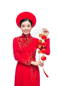 一位美丽的亚洲妇女穿着传统节服Ao Dai Tet节日 月经新年的肖像月球白色假期裙子红色女士女孩微笑礼物女性图片