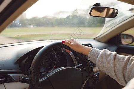 搭靠着方向盘的近身女性手 旅行者女孩在汽车旅行中 看着公路司机成人车辆运输交通驾驶车速男人图片