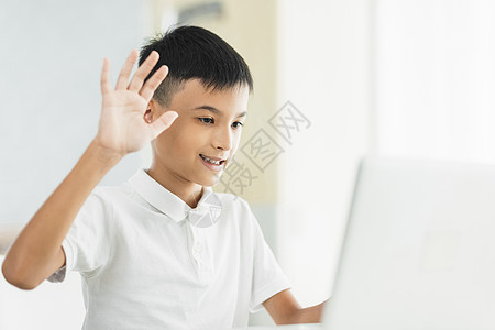 男孩用笔记本电脑学习 跟老师和同学打招呼背景图片