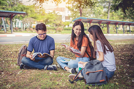 一群亚洲大学生在户外草地上阅读书籍和辅导特殊课程 幸福与教育学习理念 回到学校的概念 青少年和人的主题团体大学校园女士成人公园男图片