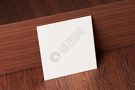 木制棕色桌子背景上的白色方形纸制名片样机 品牌展示模板印刷图形设计 一张卡片模拟 3D插画渲染小样长方形木头纸板笔记公司横幅办公图片