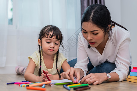 妈妈在绘画课上教女孩 女儿在家里用彩色蜡笔画画 教师在艺术课堂上培训学生 儿童主题的教育和发展 在家学习图片