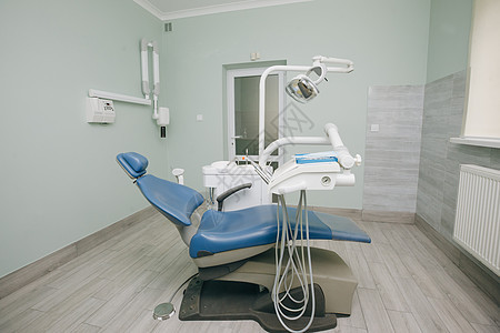 现代牙科诊所 蓝色医用灯牙医使用的牙科椅和其他配件 牙医办公室 口腔卫生 牙医椅图片