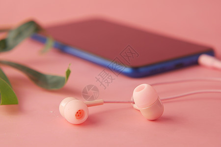 带空屏幕的智能智能电话 粉红色背景的耳机背景图片
