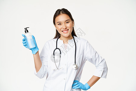 在橡胶手套中用手消毒剂 展示白本 防冠状病毒的抗食性药瓶子 以预防科罗纳病毒病人专家医院诊所商业广告疾病女孩护士感染图片