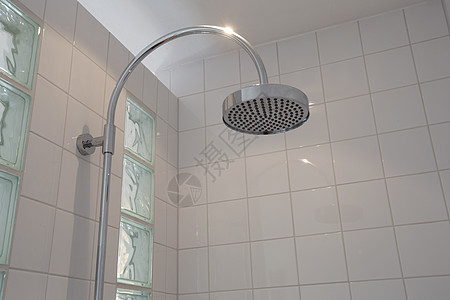 现代浴室的头顶花洒特写 配有白色瓷砖时尚的新设计图片