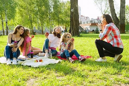 休息在公园里庆典朋友们闲暇花园午餐微笑友谊享受女性青少年图片