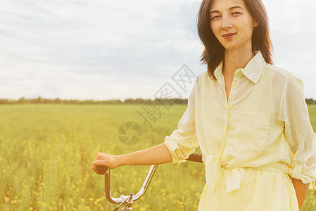 夏季青年妇女骑自行车走路的情况图片