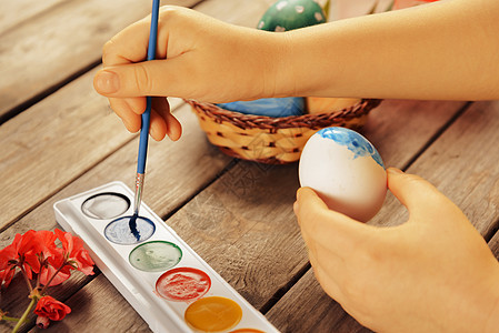 女孩在复活节给彩蛋涂彩蛋图片
