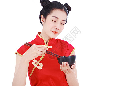 身穿中国青相服的幸福妇女 穿着筷子和白底孤立的碗快乐裙子庆典餐厅传统食物女性文化节日杯子图片