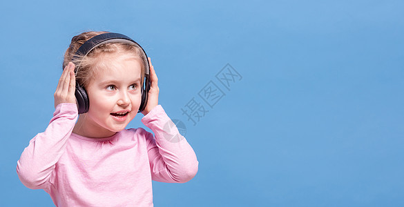带耳机的女孩听音乐的收音机青春期列表童年享受微笑互联网播放音乐蓝色图片