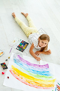 开朗小女孩画躺在地板上女孩学校姐姐幸福绘画铅笔创造力地面房间家庭作业图片