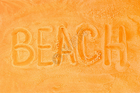 海滩一词是写在沙橙背景上 海边概念的标志或象征符号图片