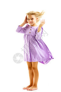 一个漂亮的小女孩立在风中 头发和衣服都在大发育 风格和时尚的概念女儿太阳天空空气微笑喜悦童年孩子闲暇女性图片