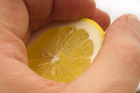 手头新鲜半柠檬饮食热带食物水果果汁白色黄色图片