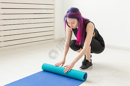 穿着彩色头发折叠体操垫和体育课课后运动垫的苗条女孩 瑜伽和小便的概念耐力活力健身房训练练习护理教练运动蓝色成人图片