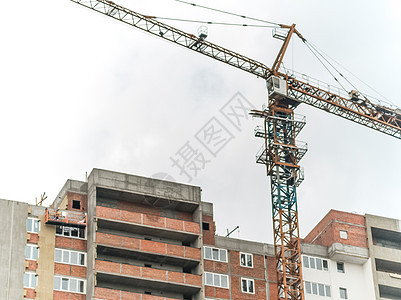 大型建筑工地 一个配备起重机的大型建筑工地脚手架建筑学公寓绳索三角帆房子水泥套管蓝色工程师图片