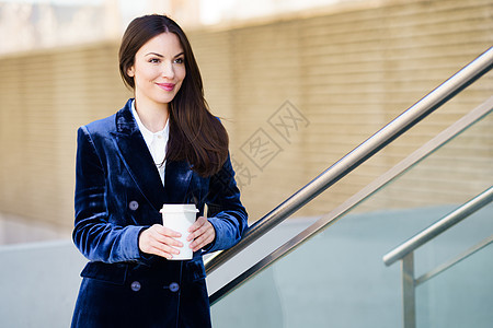 穿着蓝色西装的女商务人士在办公室外喝咖啡休息商务女孩街道发型建筑企业家成人咖啡工作经理图片