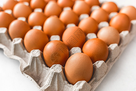 在一个纸板盘中生鸡蛋 有棕蛋和软焦点图片