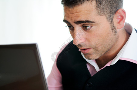成功的商务人士 戴着戴背心眼镜的眼镜和粉红色衬衫 在看一台小电脑职场互联网工人就业人士学生经理生意人笔记本思维图片