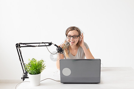 电台主持人 流媒体和博主概念  在广播电台担任电台主持人的女性坐在麦克风前互联网植物窗户女孩杯子播送车站工作室播音员手势图片